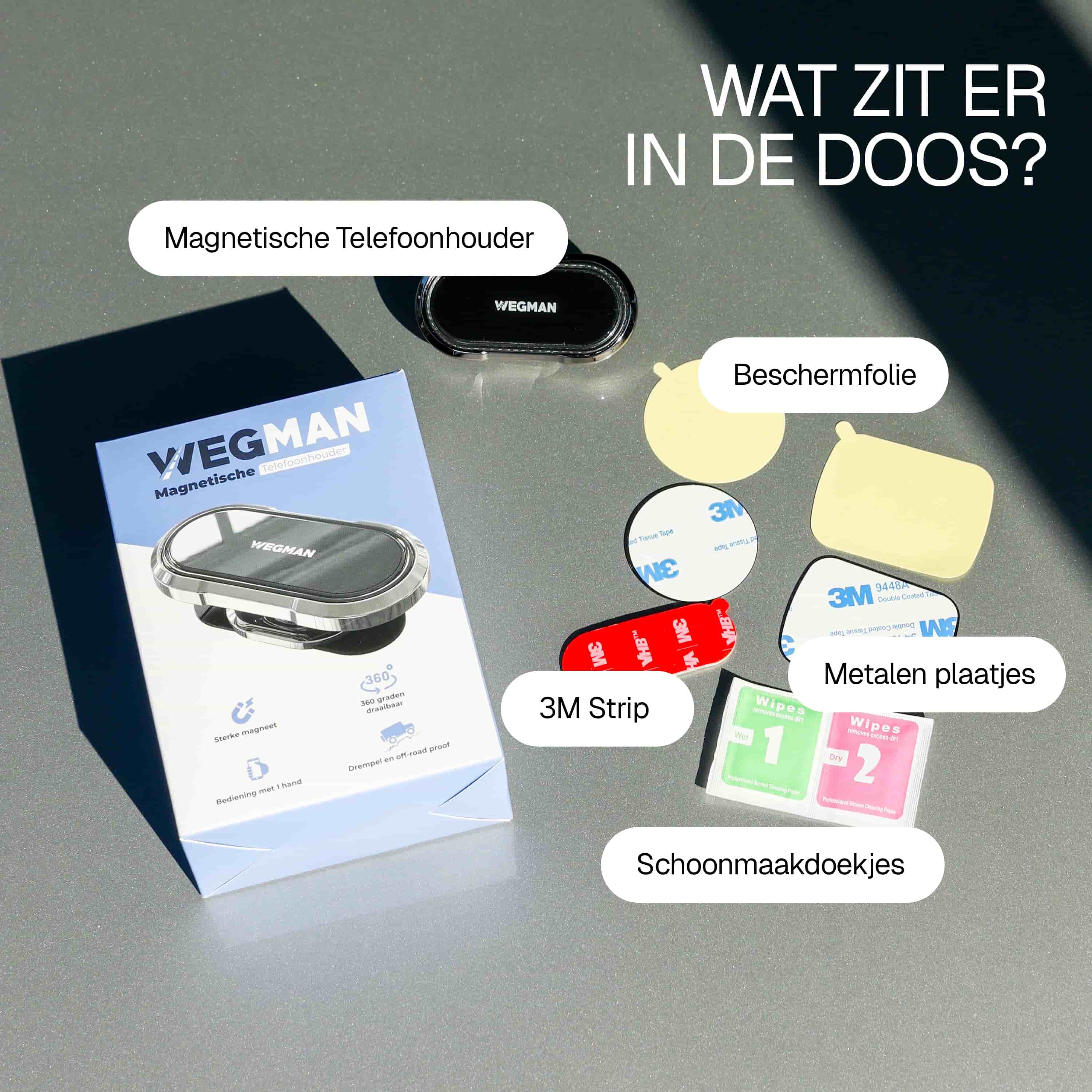 Verpakking van Wegman magnetische telefoonhouder met veel accessoires en handleiding